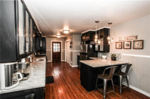 Staging example of kitchen with black cabinets.